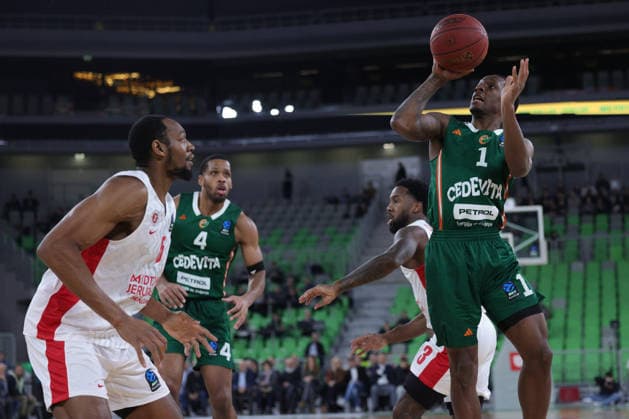 (251217) -- LJUBLJANA, Dec. 17, 2025 -- Umoja Gibson (1st R) of Cedevita Olimpija Ljubljana shoots during the BKT EuroCup 2025 26 11th round basketball match between Cedevita Olimpija Ljubljana and Hapoel Midtown Jerusalem in Ljubljana, Slovenia, on Dec. 16, 2025. (Photo by Xinhua) (SP) SLOVENIA-LJUBLJANA-BASKETBALL-BKT EUROCUP-CEDEVITA OLIMPIJA LJUBLJANA VS HAPOEL VIDTOWN JERUSALEM ZeljkoxStevanic 