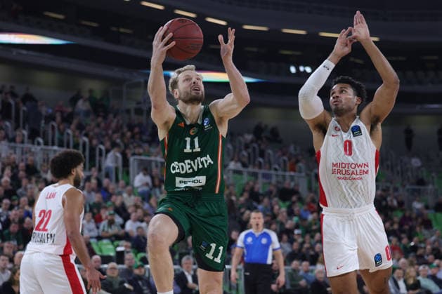 (251217) -- LJUBLJANA, Dec. 17, 2025 -- Jaka Blazic (top L) of Cedevita Olimpija Ljubljana goes for a layup during the BKT EuroCup 2025 26 11th round basketball match between Cedevita Olimpija Ljubljana and Hapoel Midtown Jerusalem in Ljubljana, Slovenia, on Dec. 16, 2025. (Photo by Xinhua) (SP) SLOVENIA-LJUBLJANA-BASKETBALL-BKT EUROCUP-CEDEVITA OLIMPIJA LJUBLJANA VS HAPOEL VIDTOWN JERUSALEM ZeljkoxStevanic 