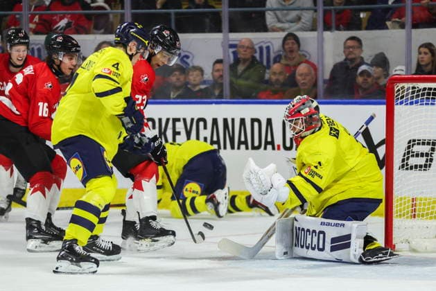 December 17, 2025, Kitchener, On, Canada: Canada s Sam O Reilly (23) fights for a puck with Sweden s Leo Sahlin Wallenius (4) in front of Sweden goaltender Herman Liv (1) during second period IIHF World Junior Hockey Championship pre-tournament action in Kitchener, Ont. on Wednesday, December 17, 2025. Canada News - December 17, 2025  - ZUMAc35_ 20251217_zaf_c35_040 Copyright: xNickxIwanyshynx