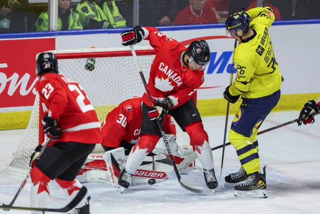 December 17, 2025, Kitchener, On, Canada: Canada s Kashawn Aitcheson (2) fights for a loose puck with Sweden s Jack Berglund (26) in front of Canada goaltender Carter George (30) during third period IIHF World Junior Hockey Championship pre-tournament action in Kitchener, Ont. on Wednesday, December 17, 2025. Canada News - December 17, 2025  - ZUMAc35_ 20251217_zaf_c35_056 Copyright: xNickxIwanyshynx