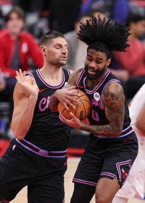 (251218) -- CHICAGO, Dec. 18, 2025 -- Chicago Bulls Coby White (R) grabs a rebound in front of Chicago Bulls Nikola Vucevic during the 2025-2026 NBA, Basketball Herren, USA regular season match between Chicago Bulls and Cleveland Cavaliers in Chicago, the United States, on Dec. 17, 2025. (Photo by Xinhua) (SP)U.S.-CHICAGO-BASKETBALL-NBA-BULLS VS CAVALIERS JoelxLerner 