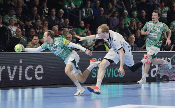 Mathias Gidsel on the ball, Eric Johansson duel Match scene Action Sport Handball DHB Cup quarter-finals mens season 2025 2026 18 12 2025 Füchse Berlin vs THW Kiel