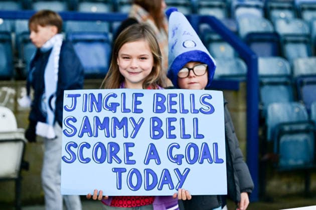 Wycombe Wanderers v Bolton Wanderers, EFL Sky Bet League 1 A young girl and boy hold up their Christmas themed banner during the EFL Sky Bet League 1 match between Wycombe Wanderers and Bolton Wanderers at Adams Park, High Wycombe, England on 20 December 2025. High Wycombe Adams Park Buckinghamshire UK Editorial use only DataCo restrictions apply See www.football-dataco.com , Copyright: xDennisxGoodwinx PSI-23453-0003