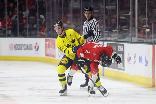 December 20, 2025, London, On, Canada: Canada defenceman Kashawn Aitcheson (right) is checked by Sweden forward Eric Nilson (28) during the first period of a IIHF World Junior Hockey Championship pre-tournament game in London, Ont., Saturday, December 20, 2025. Canada News - December 20, 2025  - ZUMAc35_ 20251220_zaf_c35_055 Copyright: xNicolexOsbornex