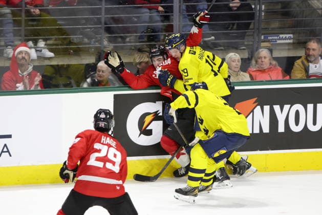 December 20, 2025, London, On, Canada: Canada forward Porter Martone (back left) gets hit by Sweden defenceman William Hakansson (19) during the third period of a IIHF World Junior Hockey Championship pre-tournament game in London, Ont., Saturday, December 20, 2025. Canada News - December 20, 2025  - ZUMAc35_ 20251220_zaf_c35_095 Copyright: xNicolexOsbornex
