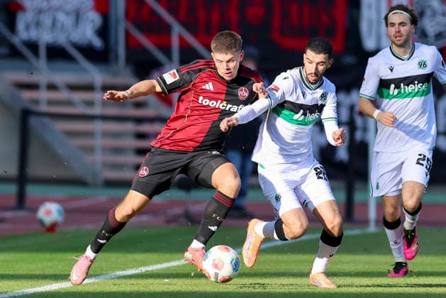 Finn Becker 1 FC Nuernberg and Waniss Taibi Hannover 96 battle for the ball, 2 Bundesliga, 1 FC Nuernberg v Hannover 96, Max Morlock Stadion on December 21, 2025 in Nuremberg, Germany Photo by Marco Steinbrenner DeFodi Images Finn Becker 1 FC Nuernberg and Waniss Taibi Hannover 96 battle for the ball, 2 Bundesliga, 1 FC Nuernberg v Hannover 96, Max Morlock Stadion, December 21, 2025 in Nuremberg, Germany Photo by Marco Steinbrenner DeFodi Images