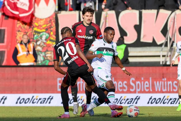 Pape Demba Diop 1 FC Nuernberg , Tom Baack 1 FC Nuernberg and Noel Aseko Hannover 96 battle for the ball, 2 Bundesliga, 1 FC Nürnberg v Hannover 96, Max Morlock Stadion, December 21, 2025 in Nuremberg, Germany Photo by Marco Steinbrenner DeFodi Images Pape Demba Diop 1 FC Nuernberg , Tom Baack 1 FC Nuernberg and Noel Aseko Hannover 96 battle for the ball, 2 Bundesliga, 1 FC Nürnberg v Hannover 96, Max Morlock Stadion, December 21, 2025 in Nuremberg, Germany Photo by Marco Steinbrenner DeFodi Images