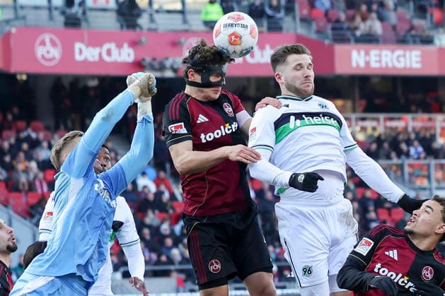 Goalkeeper Jan Reichert 1 FC Nuernberg , Fabio Gruber 1 FC Nuernberg and Benjamin Kaellmann Hannover 96 battle for the ball, 2 Bundesliga, 1 FC Nürnberg v Hannover 96, Max Morlock Stadion, December 21, 2025 in Nuremberg, Germany Photo by Marco Steinbrenner DeFodi Images Goalkeeper Jan Reichert 1 FC Nuernberg , Fabio Gruber 1 FC Nuernberg and Benjamin Kaellmann Hannover 96 battle for the ball, 2 Bundesliga, 1 FC Nürnberg v Hannover 96, Max Morlock Stadion, December 21, 2025 in Nuremberg, Germany Photo by Marco Steinbrenner DeFodi Images