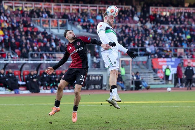 Berkay Yilmaz 1 FC Nuremberg and Benjamin Kaellmann Hannover 96 battle for the ball, 2 Bundesliga, 1 FC Nuremberg v Hannover 96, Max Morlock Stadion on December 21, 2025 in Nuremberg, Germany Photo by Marco Steinbrenner DeFodi Images Berkay Yilmaz 1 FC Nuremberg and Benjamin Kaellmann Hannover 96 battle for the ball, 2 Bundesliga, 1 FC Nuremberg v Hannover 96, Max Morlock Stadion, December 21, 2025 in Nuremberg, Germany Photo by Marco Steinbrenner DeFodi Images