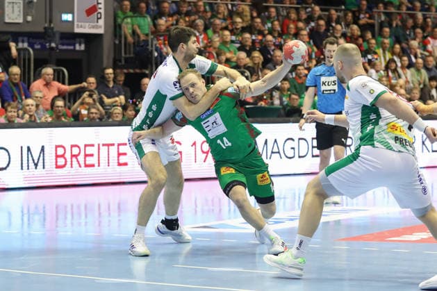 21 12 2025, xgox, Handball Daikin HBL SC Magdeburg SC DHfK Leipzig emspor, v l Marko Mamic Leipzig, 14 , Omar Ingi Magnusson Magdeburg, 14 duel, duel, fight, tackle Magdeburg