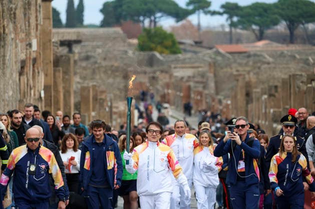 Pompei: December 22, 2025, Milan-Cortina 2026 Winter Olympics. The photo shows the Olympic torch passing through the Archaeological Park. Actor Jackie Chan  Copyright: xAlessandroxGarofalo LaPressex