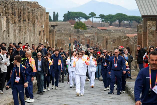 Pompei: December 22, 2025, Milan-Cortina 2026 Winter Olympics. The photo shows the Olympic torch passing through the Archaeological Park. Actor Jackie Chan  Copyright: xAlessandroxGarofalo LaPressex