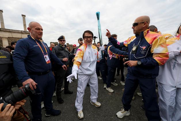 Pompei: December 22, 2025, Milan-Cortina 2026 Winter Olympics. The photo shows the Olympic torch passing through the Archaeological Park. Actor Jackie Chan  Copyright: xAlessandroxGarofalo LaPressex