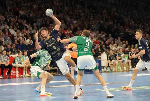 Photo Goal throw from Jacob Arenth LASSEN HSV against Matthes Langhoff Füchse Füchse and right Max DARJ Füchse Handball Men 1 Bundesliga on Tue 23 12 2025 HSV Handball Füchse Berlin