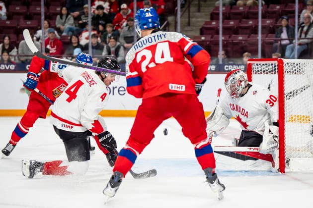 December 26, 2025, Minneapolis, Mn, Canada: Czechia s Vojtech Cihar (15) and Adam Novotny (24) attack the net while Canada s Harrison Brunicke (4) and goaltender Carter George (30) defend, during third period IIHF World Junior Championship hockey action, in Minneapolis, Friday, Dec. 26, 2025. Canada News - December 26, 2025 - ZUMAc35_ 20251226_zaf_c35_091 Copyright: xChristopherxKatsarovx