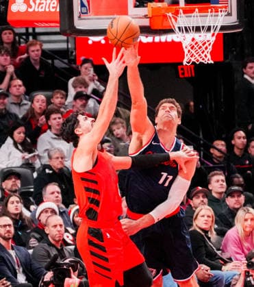 (251227) -- PORTLAND, Dec. 27, 2025 -- Brook Lopez (R) of Los Angeles Clippers blocks Deni Avdija of Portland Trail Blazers during the 2025-2026 NBA, Basketball Herren, USA regular season match between Portland Trail Blazers and Los Angeles Clippers in Portland, the United States, Dec. 26, 2025. (Photo by Xinhua) (SP)U.S.-PORTLAND-BASKETBALL-NBA-CLIPPERS VS BLAZERS SunxYuxuan 