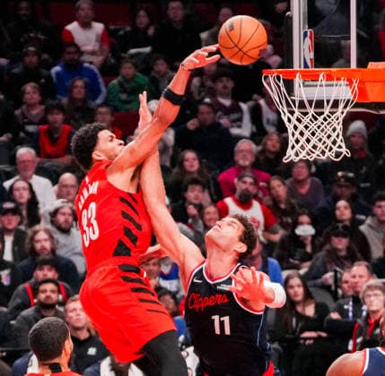 (251227) -- PORTLAND, Dec. 27, 2025 -- Toumani Camara (L) of Portland Trail Blazers shoots past Brook Lopez of Los Angeles Clippers during the 2025-2026 NBA, Basketball Herren, USA regular season match between Portland Trail Blazers and Los Angeles Clippers in Portland, the United States, Dec. 26, 2025. (Photo by Xinhua) (SP)U.S.-PORTLAND-BASKETBALL-NBA-CLIPPERS VS BLAZERS SunxYuxuan 