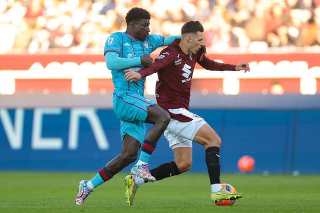 Turin, Italy, 27th December 2025. Ndary Adopo of Cagliari Calcio tussles with Gvidas Gineitis of Torino FC as he breaks with the ball during the Torino vs Cagliari Serie A match at Stadio Grande Torino, Turin. Picture credit should read: Jonathan Moscrop Sportimage EDITORIAL USE ONLY. No use with unauthorised audio, video, data, fixture lists, club league logos or live services. Online in-match use limited to 120 images, no video emulation. No use in betting, games or single club league player publications. SPI_130_JM_TORO_CAGLIARI SPI-4366-0129