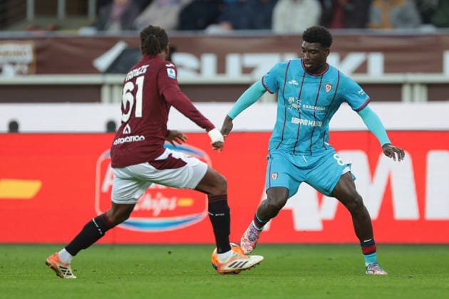 Turin, Italy, 27th December 2025. Ndary Adopo of Cagliari Calcio takes on former team mate Adrien Tameze of Torino FC during the Torino vs Cagliari Serie A match at Stadio Grande Torino, Turin. Picture credit should read: Jonathan Moscrop Sportimage EDITORIAL USE ONLY. No use with unauthorised audio, video, data, fixture lists, club league logos or live services. Online in-match use limited to 120 images, no video emulation. No use in betting, games or single club league player publications. SPI_156_JM_TORO_CAGLIARI SPI-4366-0155