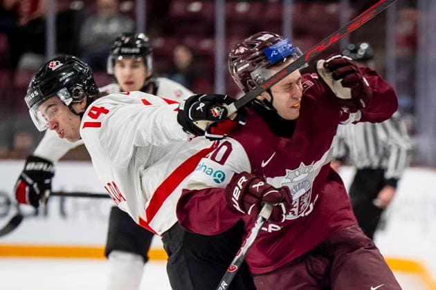 December 27, 2025, Minneapolis, Mn, Canada: Canada s Ben Danford (14) hits Latvia s Kristians Utnans (20) with a stick during second period IIHF World Junior Championship hockey action, in Minneapolis, Saturday, Dec. 27, 2025. Canada News - December 27, 2025  - ZUMAc35_ 20251227_zaf_c35_085 Copyright: xChristopherxKatsarovx