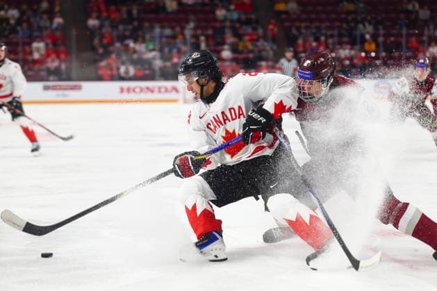 December 27, 2025, Minneapolis, Minnesota, United States: Canada forward MICHAEL HAGE (29) stops to collect the puck in front of a Latvian defender. Canada and Latvia faced off in the opening round of the IIHF World Junior Championship on December 27th. Canada was victorious, winning 2-1 in overtime. Minneapolis United States - ZUMAt166 20251227_zsp_t166_001 Copyright: xMichaelxTurnerx