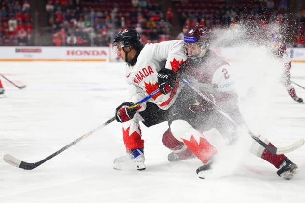 December 27, 2025, Minneapolis, Minnesota, United States: Canada forward MICHAEL HAGE (29) collects the puck and sprays Latvia defender KRISJANIS SARTS (2) with ice. Canada and Latvia faced off in the opening round of the IIHF World Junior Championship on December 27th. Canada was victorious, winning 2-1 in overtime. Minneapolis United States - ZUMAt166 20251227_zsp_t166_004 Copyright: xMichaelxTurnerx