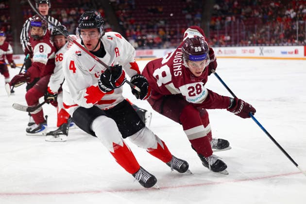 December 27, 2025, Minneapolis, Minnesota, United States: Latvia forward KARLIS FLUGINS (28) and Canada defender HARRISON BRUNICKE (4) follow the puck into the corner. Canada and Latvia faced off in the opening round of the IIHF World Junior Championship on December 27th. Canada was victorious, winning 2-1 in overtime. Minneapolis United States - ZUMAt166 20251227_zsp_t166_014 Copyright: xMichaelxTurnerx