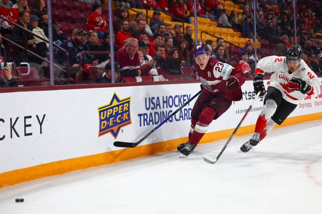 December 27, 2025, Minneapolis, Minnesota, United States: Latvia forward ALBERTS SMITS (23) and Canada defender KASHAWN AITCHESON (2) follow the puck into the corner. Canada and Latvia faced off in the opening round of the IIHF World Junior Championship on December 27th. Canada was victorious, winning 2-1 in overtime. Minneapolis United States - ZUMAt166 20251227_zsp_t166_019 Copyright: xMichaelxTurnerx