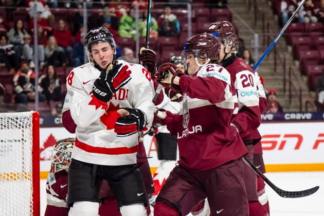 December 27, 2025, Minneapolis, Mn, Canada: Latvia s Markuss Sieradzkis (27) hits Canada s Brady Martin (28) during third period IIHF World Junior Championship hockey action, in Minneapolis, Saturday, Dec. 27, 2025. Canada News - December 27, 2025  - ZUMAc35_ 20251227_zaf_c35_103 Copyright: xChristopherxKatsarovx