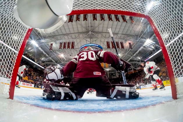 December 27, 2025, Minneapolis, Mn, Canada: Latvia goaltender Nils Maurins (30) defends against Canada s Tij Iginla (11),left and Porter Martone (22) during second period IIHF World Junior Championship hockey action, in Minneapolis, Saturday, Dec. 27, 2025. Canada News - December 27, 2025 - ZUMAc35_ 20251227_zaf_c35_108 Copyright: xChristopherxKatsarovx