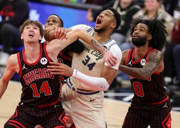 (251228) -- CHICAGO, Dec. 28, 2025 -- Matas Buzelis (1st L) and Coby White (1st R) of Chicago Bulls battle for position with Giannis Antetokounmpo (2nd R) of Milwaukee Bucks during NBA, Basketball Herren, USA regular season basketball game between Milwaukee Bucks and Chicago Bulls at United Center in Chicago, the United States, on Dec. 27, 2025. (Photo by Xinhua) (SP)U.S.-CHICAGO-BASKETBALL-NBA-BUCKS VS BULLS JoelxLerner 