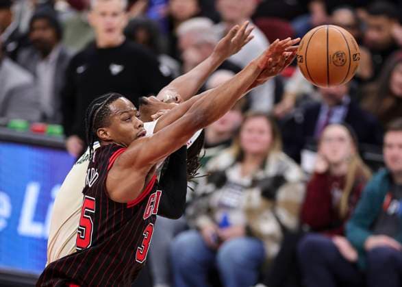 (251228) -- CHICAGO, Dec. 28, 2025 -- Isaac Okoro (front) of Chicago Bulls and Myles Turner of Milwaukee Bucks battle for the ball during NBA, Basketball Herren, USA regular season basketball game between Milwaukee Bucks and Chicago Bulls at United Center in Chicago, the United States, on Dec. 27, 2025. (Photo by Xinhua) (SP)U.S.-CHICAGO-BASKETBALL-NBA-BUCKS VS BULLS JoelxLerner 