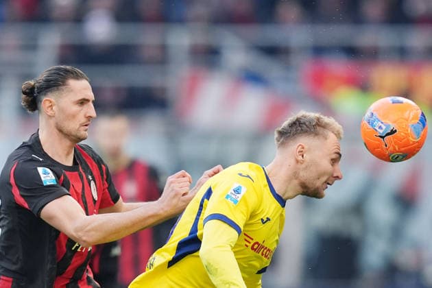 AC Milan s Adrien Rabiot fights for the ball with Verona™s Victor Nelsson during the Serie A soccer match between Milan and Hellas Verona at the San Siro Stadium in Milan , north Italy - Sunday , December 28 , 2025. - Soccer .  Copyright: xSpada LaPressex