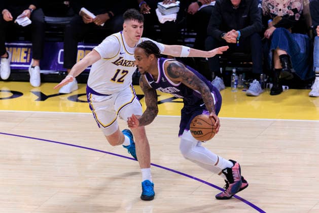 December 28, 2025, Los Angeles, California, USA: Jake LaRavia 12 of the Los Angeles Lakers guards DeMar DeRozan 10 of the Sacramento Kings during their regular season NBA, Basketball Herren, USA game on Sunday December 28, 2025 at Crypto.com Arena in Los Angeles, California. Lakers defeat Kings, 125-101. ARIANA RUIZ PI Los Angeles USA - ZUMAp124 20251228_zaa_p124_037 Copyright: xArianaxRuizx