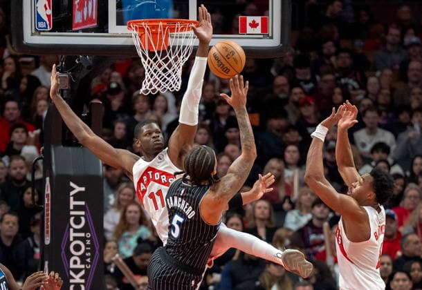 December 29, 2025, Toronto, On, Canada: Toronto Raptors centre Mo Bamba (11) and forward Scottie Barnes (right) defend against Orlando Magic forward Paolo Banchero (5) as he shoots during first half NBA, Basketball Herren, USA action in Toronto on Monday December 29, 2025. Canada News - December 29, 2025  - ZUMAc35_ 20251229_zaf_c35_043 Copyright: xFrankxGunnx