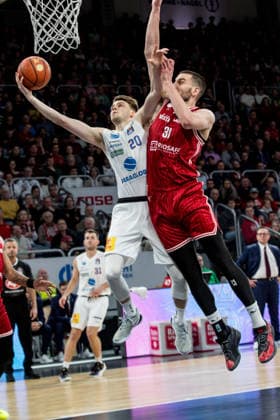 Bamberg, Germany December 30, 2025 1 BBL 2025 2026 BMA365 Bamberg Baskets vs Syntainics MBC In the picture from left under the basket Perttu Blomgren MBC Weißenfels against Daniel Keppeler Bamberg Brose Arena Bayern Copyright: xFotostandx xSchmittx