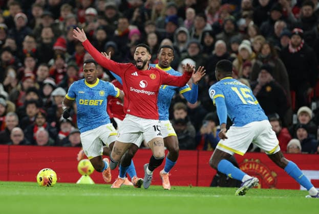 30th December 2025; Old Trafford, Manchester, England; Premier League Football, Manchester United, ManU versus Wolverhampton Wanderers; Matheus Cunha of Manchester United is fouled by Wolves players  RogerxEvans