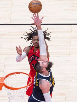 (260101) -- TORONTO, Jan. 1, 2026 -- Collin Murray-Boyles (top) of Toronto Raptors is blocked by Jonas Valanciunas of Denver Nuggets during the 2025-2026 NBA, Basketball Herren, USA regular season game between Toronto Raptors and Denver Nuggets in Toronto, Canada, Dec. 31, 2025. (Photo by Xinhua) (SP) CANADA-TORONTO-NBA-NUGGETS VS RAPTORS ZouxZheng 