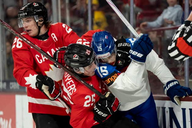 January 2, 2026, Minneapolis, Mn, USA: Canada s Caleb Desnoyers (25) and Slovakia s Andreas Straka (15) battle while Canada s Cole Beaudoin (26) looks on during first period IIHF World Junior Championship quarterfinal hockey action, in Minneapolis, Minn., on Friday, January 2, 2026. Canada News - January 2, 2026 - ZUMAc35_ 20260102_zaf_c35_013 Copyright: xChristopherxKatsarovx