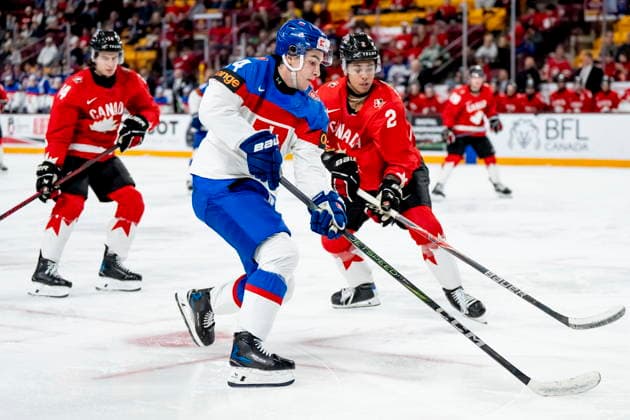 January 2, 2026, Minneapolis, Mn, USA: Slovakia s Alex Misiak (14) is defended by Canada s Kashawn Aitcheson (2) and Ben Danford (14) as he attacks the net during third period IIHF World Junior Championship quarterfinal hockey action, in Minneapolis, Minn., on Friday, January 2, 2026. Canada News - January 2, 2026 - ZUMAc35_ 20260102_zaf_c35_031 Copyright: xChristopherxKatsarovx