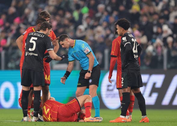 Turin, Italy, 3rd January 2026. The Referee Giuseppe Collu looks over Francesco Camarda of US Lecce as he lays injured after twisting his ankle during the Juventus vs Lecce Serie A match at Allianz Stadium, Turin. Picture credit should read: Jonathan Moscrop Sportimage EDITORIAL USE ONLY. No use with unauthorised audio, video, data, fixture lists, club league logos or live services. Online in-match use limited to 120 images, no video emulation. No use in betting, games or single club league player publications. SPI_028_JM_JUVE_LECCE SPI-4406-0028