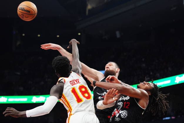 January 3, 2026, Toronto, On, Canada: Atlanta Hawks Mouhamed Gueye (18) defends against Toronto Raptors Sandro Mamukelashvili (centre) and Collin Murray-Boyles (12) during first half NBA, Basketball Herren, USA basketball action in Toronto on Saturday, Jan. 3, 2026. Canada News - January 3, 2026  - ZUMAc35_ 20260103_zaf_c35_081 Copyright: xFrankxGunnx