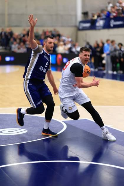 Scene with Paul Zipser 9 MLP Academics Heidelberg and 8 Basketball Nymburk in intense duel Basketball Champions League MLP Academics Heidelberg - ERA Basketball Nymburk Paul Zipser 9 MLP Academics Heidelberg in duel with 8 Basketball Nymburk Copyright: xspeedshotx