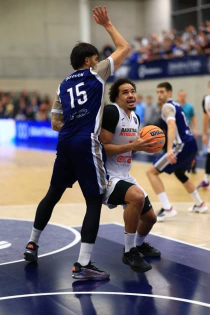Game action with Marcus Santos Silva 7 Basketball Nymburg and a player from MLP Academics Heidelberg Basketball Champions League MLP Academics Heidelberg - ERA Basketball Nymburk Marcus Santos Silva 7 Basketball Nymburg with ball in action Copyright: xspeedshotx