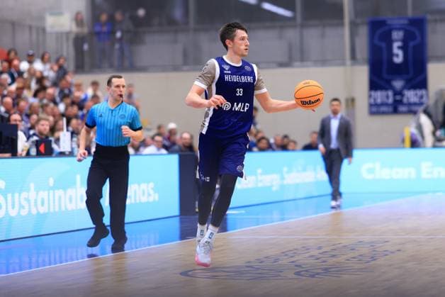 Game action with Ryan Mikesell 33 MLP Academics Heidelberg Basketball Champions League MLP Academics Heidelberg - ERA Basketball Nymburk Ryan Mikesell 33 MLP Academics Heidelberg with ball in action Copyright: xspeedshotx