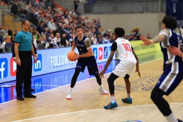 Game action with Ryan Mikesell 33 MLP Academics Heidelberg and Sir Jabari Rice 10 Basketball Nymburk on the court Basketball Champions League MLP Academics Heidelberg - ERA Basketball Nymburk Ryan Mikesell 33 MLP Academics Heidelberg with ball against Sir Jabari Rice 10 Basketball Nymburk Copyright: xspeedshotx