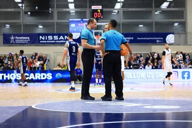 Scene with DJ Horne 0 MLP Academics Heidelberg , Paul Zipser 9 MLP Academics Heidelberg , Osun Osunniyi 12 MLP Academics Heidelberg and Martin Kriz 31 Basketball Nymburg as well as referees on the court Basketball Champions League MLP Academics Heidelberg - ERA Basketball Nymburk Scene with players and referees Copyright: xspeedshotx