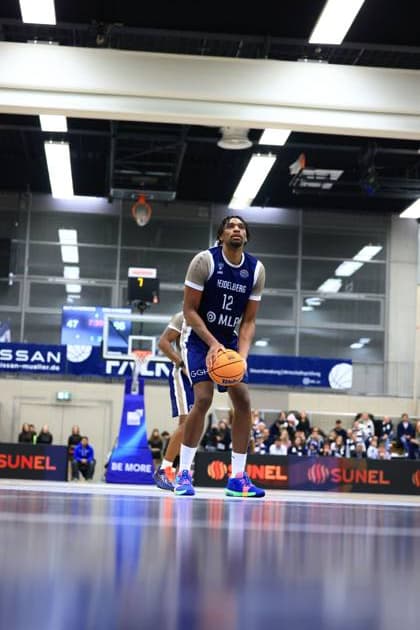 Game action with Osun Osunniyi 12 MLP Academics Heidelberg in blue jersey with ball in hand Basketball Champions League MLP Academics Heidelberg - ERA Basketball Nymburk Osun Osunniyi 12 MLP Academics Heidelberg with ball in action Copyright: xspeedshotx