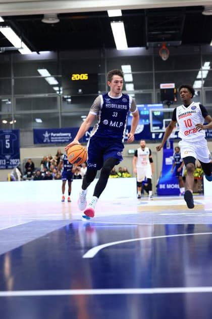 Game action with Ryan Mikesell 33 MLP Academics Heidelberg and Sir Jabari Rice 10 Basketball Nymburk on the court Basketball Champions League MLP Academics Heidelberg - ERA Basketball Nymburk Ryan Mikesell 33 MLP Academics Heidelberg with ball against Sir Jabari Rice 10 Basketball Nymburk Copyright: xspeedshotx