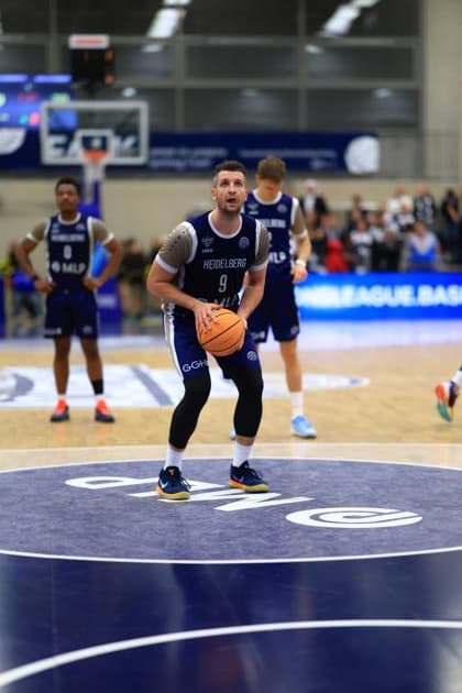 Game action with Paul Zipser 9 MLP Academics Heidelberg , DJ Horne 0 MLP Academics Heidelberg and Samuell Williamson 10 MLP Academics Heidelberg Basketball Champions League MLP Academics Heidelberg - ERA Basketball Nymburk Paul Zipser 9 MLP Academics Heidelberg with ball in action Copyright: xspeedshotx